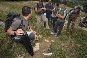 Umberto Esposito, mountain guide and CEO at Wildlife Adventures, partner of Rewilding Europe in the Apennines, showing wolf scat while leading a group for a bear watching excursion. Abruzzo National Park. 