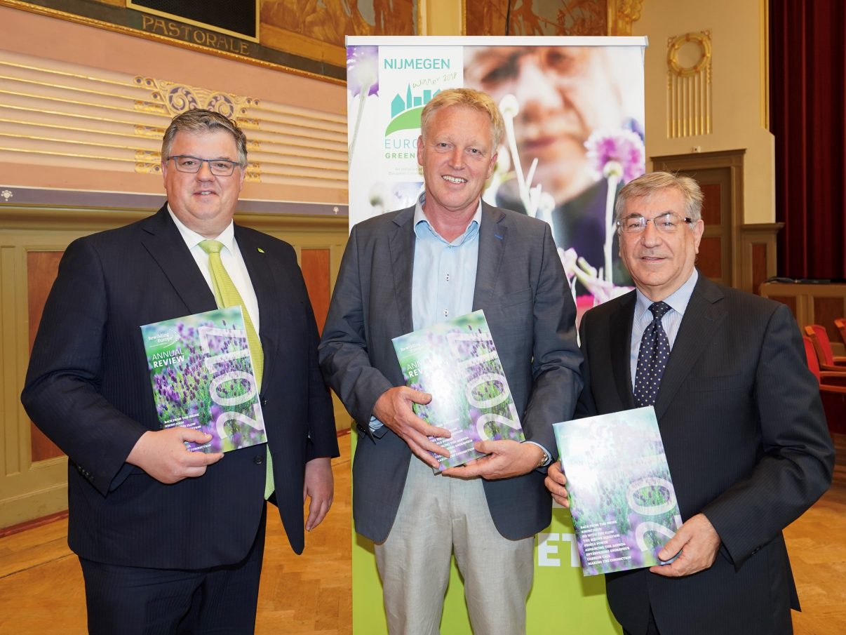 Frans Schepers, Managing Director of Rewilding Europe (centre) presents Karmenu Vella, European Commissioner for Environment, Fisheries and Maritime Affairs (right) and Hubert Bruls, Mayor of Nijmegen (left) with a copy of the Rewilding Europe Annual Review 2017, prior to a ceremony announcing the European Green Capital for 2020 that took place in Nijmegen on June 21. Photo by: Jan Willem de Venster