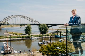 King Willem-Alexander overlooking the river Waal in Nijmegen.