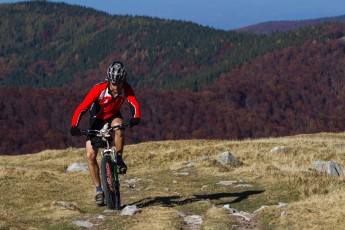 Mountain biker riding the slopes of the Tarcu Mountains, Southern Carpathians, Romania