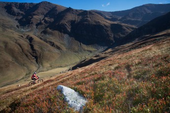 Mountain biker riding the slopes of the Tarcu Mountains, Southern Carpathians, Romania