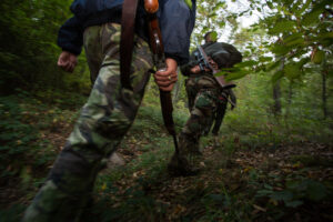 Romanian hunters during a driving hunt for Wild boar (Sus scrofa) in the forest area outside the village of Mehadia, Caras Severin, Romania.