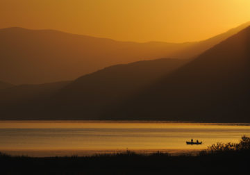 Fishermen at Lake Prespa in sunrise. Lake Prespa National Park, Albania June 2009