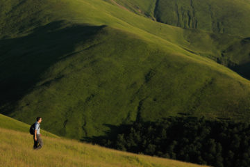 Ecotourist Niel Birnie. Alpine grasslands in the Tarku mountains Natura 2000 site, Southern Carpathians, Romania, Rewilding Europe site