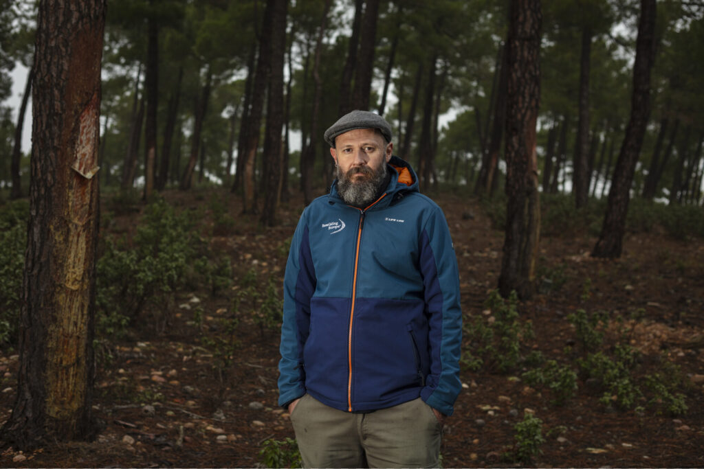 Portrait of Enterprise Officer Basilio Rodríguez García amongst resin tapping trees in Iberian Highlands