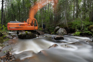 after river restoration, more connection to the forest , crane working on river restoration